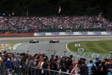 Fans watching the F1 cars at the British Grand Prix