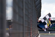 British GT prize winner waves the chequered flag