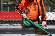A marshal waves the green flag to start the session