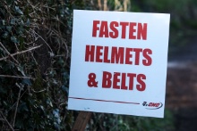 Fasten helmets and belts sign at the start of a stage