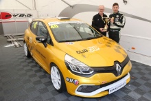 Mike Robinson receives his championship Trophy for winning the Michelin Clio Cup series from Jeremy Townsend of Renault UK