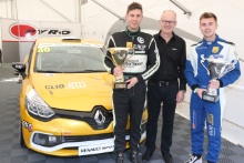 Mike Robinson and Anton Spires receive the championship trophies  for winning the Michelin Clio Cup series' from Jeremy Townsend of Renault UK
