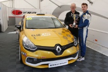 Anton Spires  receives his championship Trophy for winning the Michelin Clio Cup series from Jeremy Townsend of Renault UK
