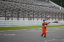 Marshals clean the track