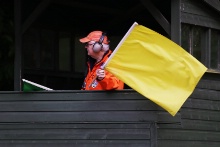 Marshal waving yellow flag