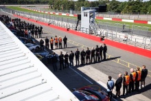 Teams and drivers observe a two minute silence