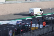 Marshals clean the track after a fire